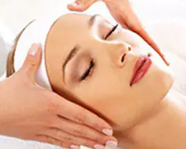 A woman getting her face washed with hands.