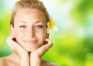 A beautiful young lady with a flower in her hair.