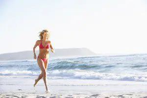 Smiling woman after breast augmentation consultation at Thaxton Plastic Surgery