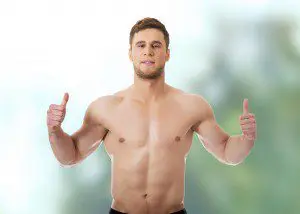 A man giving two thumbs up while wearing black shorts.