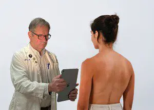 Client consulting with a breast augmentation surgeon near Huntington, WV.
