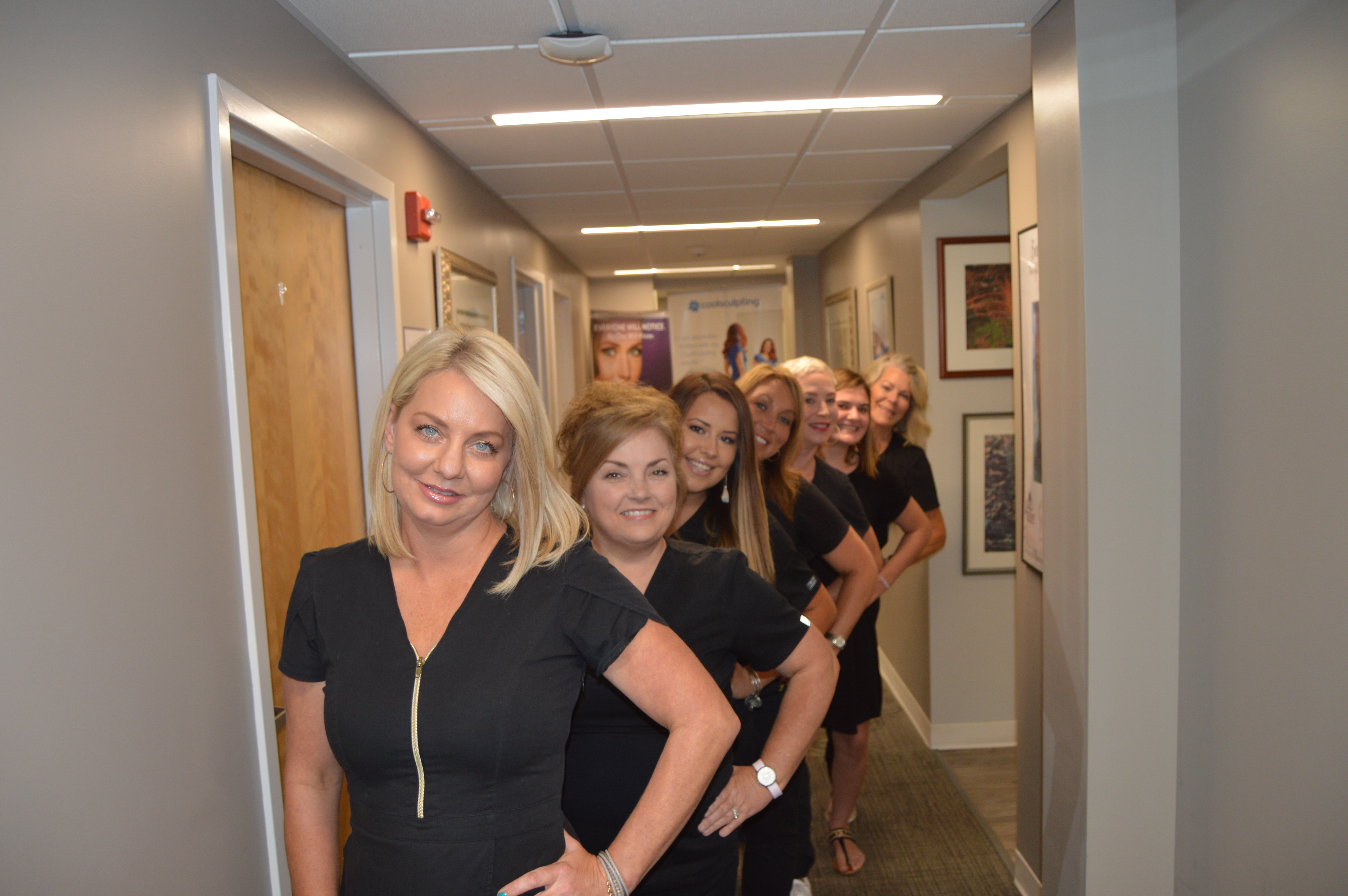 A group of women standing in a hallway.